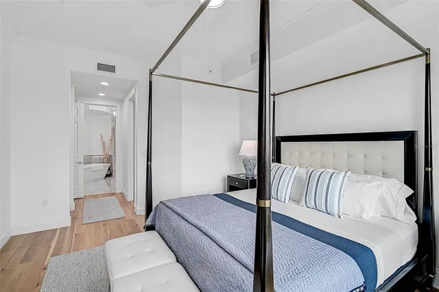 a bedroom with a bed and a mirror