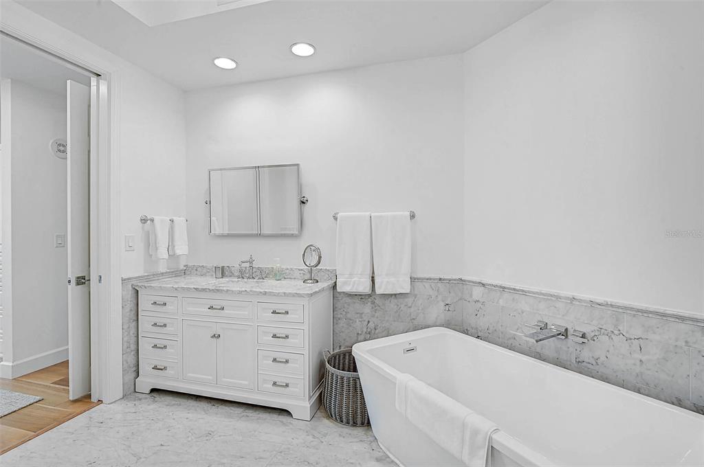 409 North Point Road, Unit 802 Osprey, FL 34229 - Photo 21 of 38 a bathroom with a tub sink and mirror