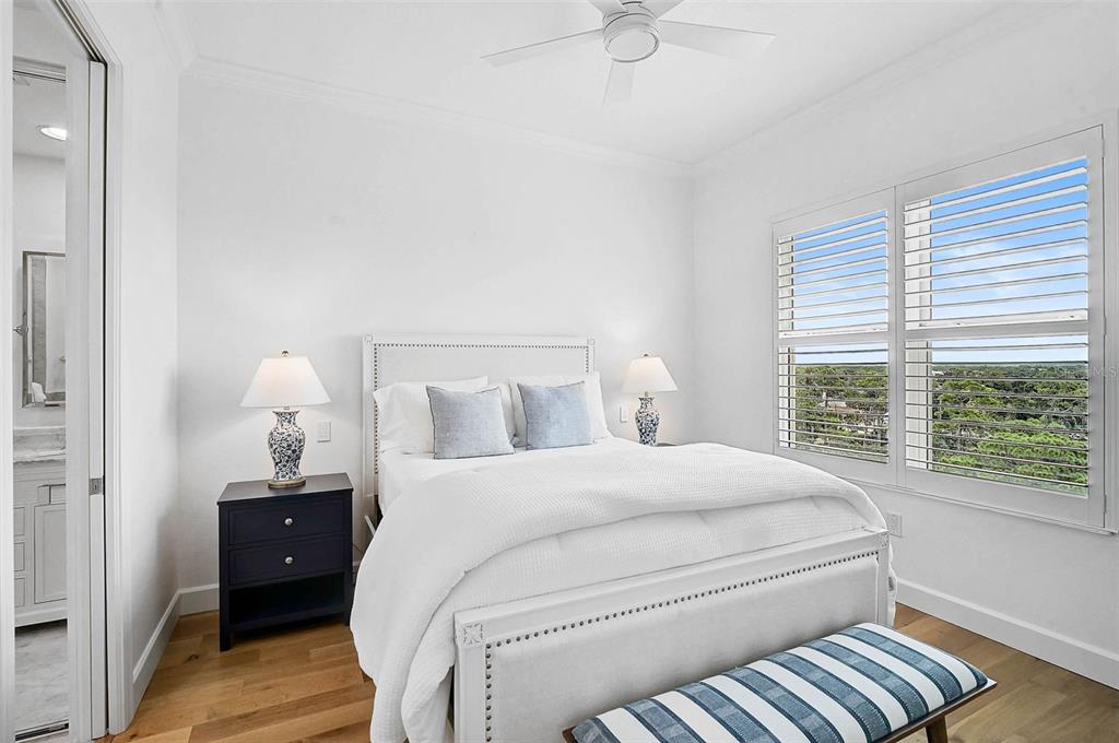 409 North Point Road, Unit 802 Osprey, FL 34229 - Photo 25 of 38 a bedroom with a bed and a large window