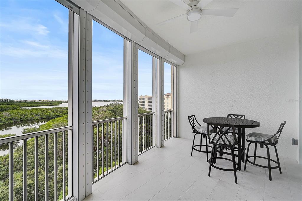 409 North Point Road, Unit 802 Osprey, FL 34229 - Photo 30 of 38 a view of a patio with a table and chairs