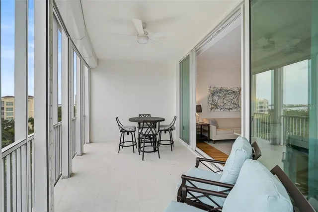 a view of a livingroom with furniture and floor to ceiling window