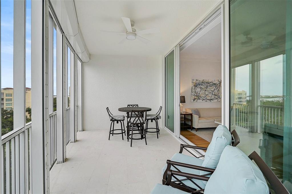 409 North Point Road, Unit 802 Osprey, FL 34229 - Photo 31 of 38 a view of a livingroom with furniture and floor to ceiling window