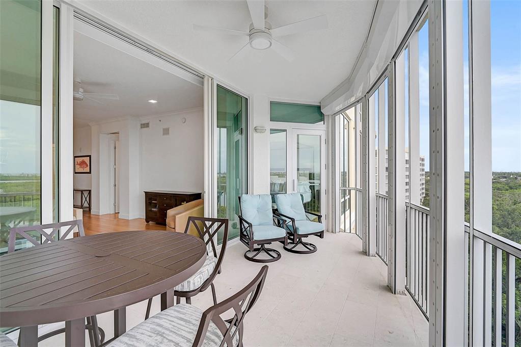 409 North Point Road, Unit 802 Osprey, FL 34229 - Photo 32 of 38 a view of a livingroom with furniture and floor to ceiling window