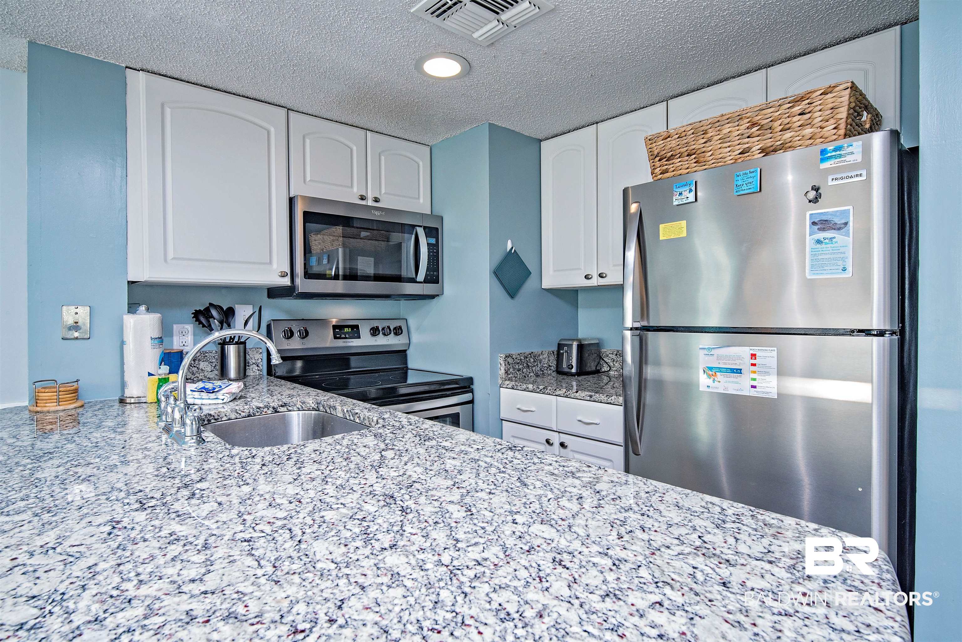 497 Plantation Road, Unit 1156 Gulf Shores, AL 36542 - Photo 4 of 28 Kitchen with white cabinetry, sink, a textured ceiling, and appliances with stainless steel finishes