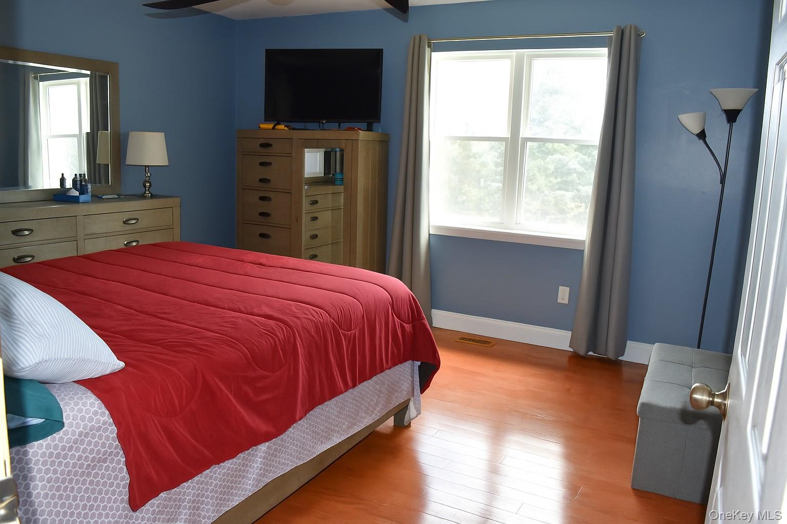 21 Walden Estates Road Walden, NY 12586 - Photo 11 of 32 Bedroom featuring multiple windows, light wood-style flooring, and a ceiling fan