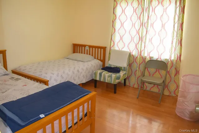 a bedroom with a bed and a night stand