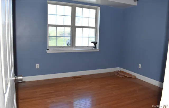 wooden floor and window in an empty room