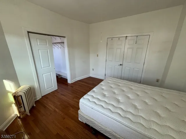 a spacious bedroom with a bed and furniture