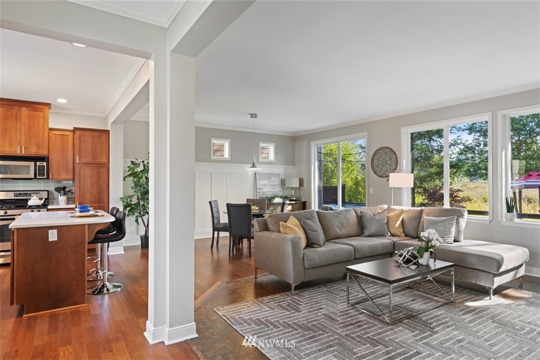 3615 182nd Street Southeast, Unit 74 Bothell, WA 98012 - Photo 14 of 33 a living room with furniture floor to ceiling window and wooden floor