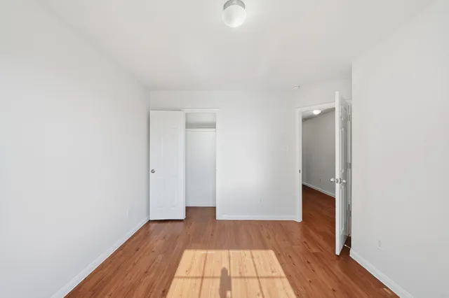 a view of a room with wooden floor and a sink