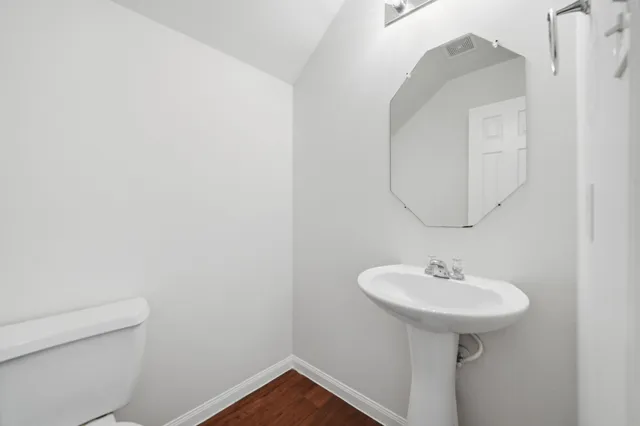 a bathroom with a sink a mirror and a toilet