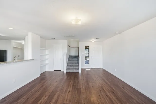 a view of a room with wooden floors and led lights