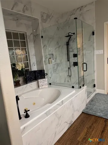 a kitchen with granite countertop white cabinets and stainless steel appliances