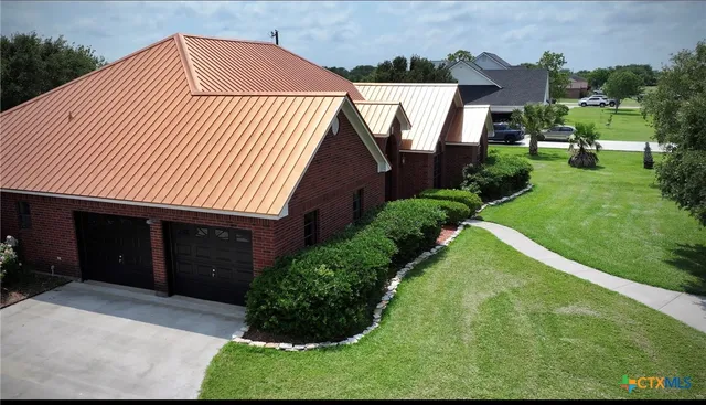 an aerial view of a house with garden space and street view