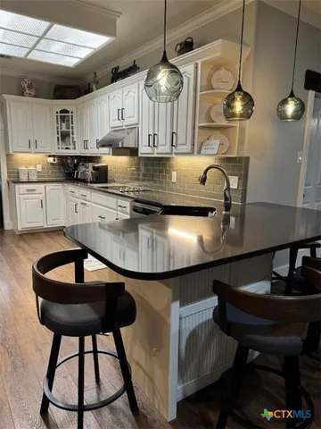 a dining room with furniture a large window and wooden floor