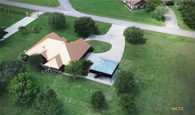 a kitchen with stainless steel appliances granite countertop a sink a stove and a wooden floors