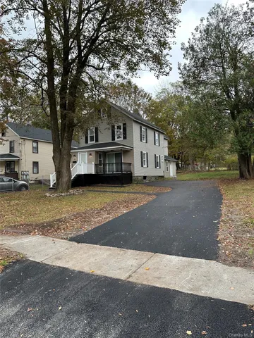 a view of a house with a large tree