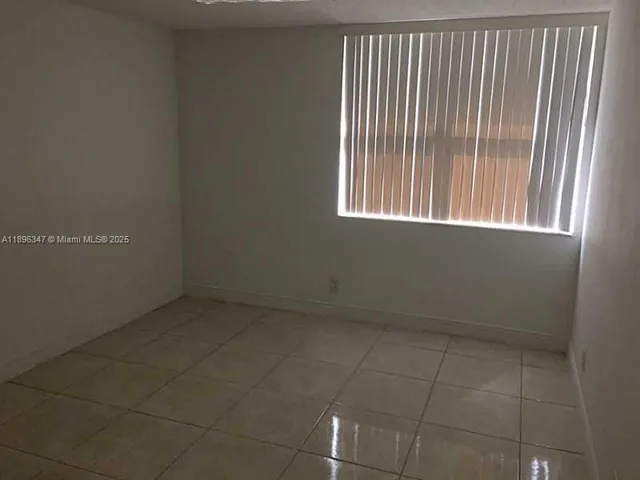 a view of a livingroom with an empty space and window
