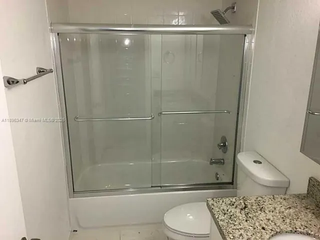 a bathroom with a shower and a toilet