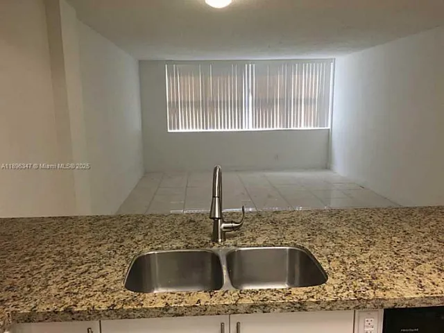 a kitchen with granite countertop a sink and granite top