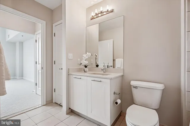 a view of a hallway with wooden floor and closet
