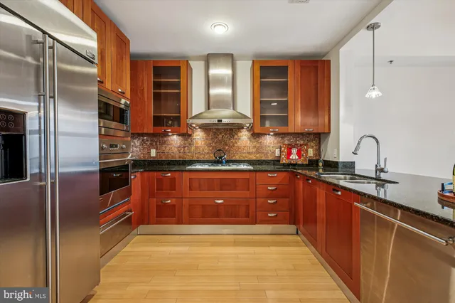 a view of a kitchen and a chandelier fan