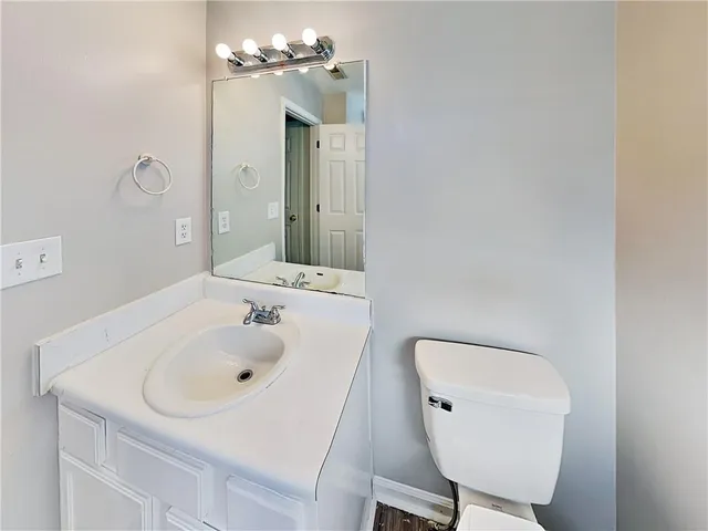 a bathroom with a sink a toilet and mirror