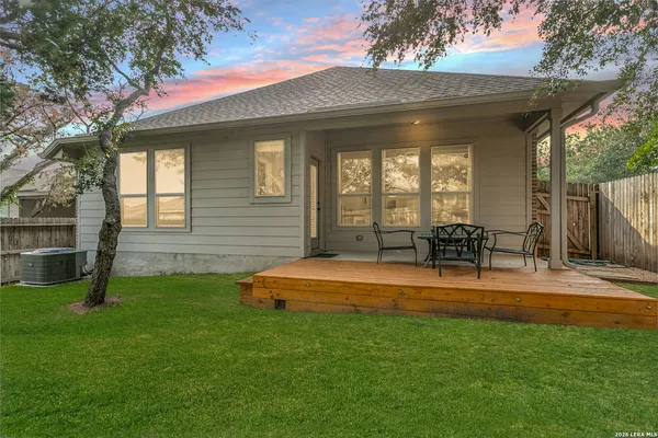 a view of a house with a backyard patio and swimming pool