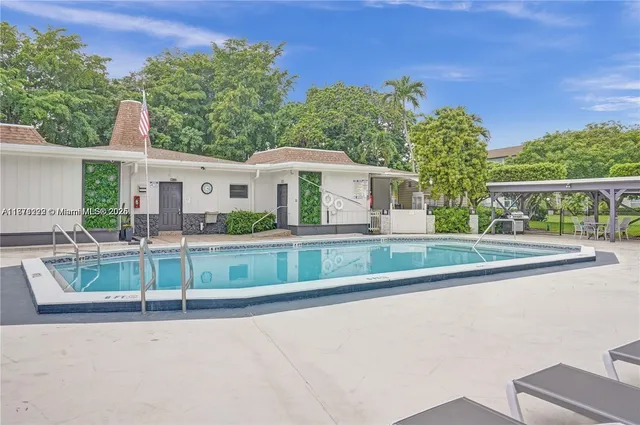 a view of swimming pool with outdoor seating