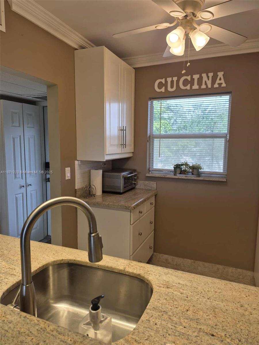 3400 Northwest 48th Avenue, Unit 607 Lauderdale Lakes, FL 33319 - Photo 4 of 17 a kitchen with a sink cabinets and window