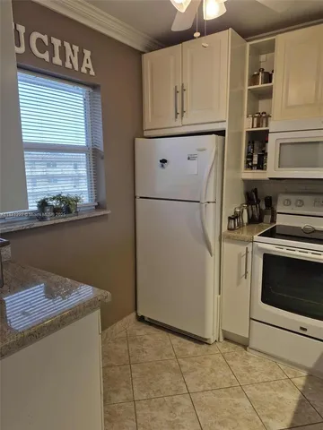a kitchen with appliances cabinets and a window