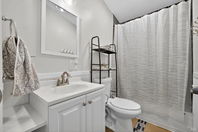 a bathroom with a sink toilet and mirror