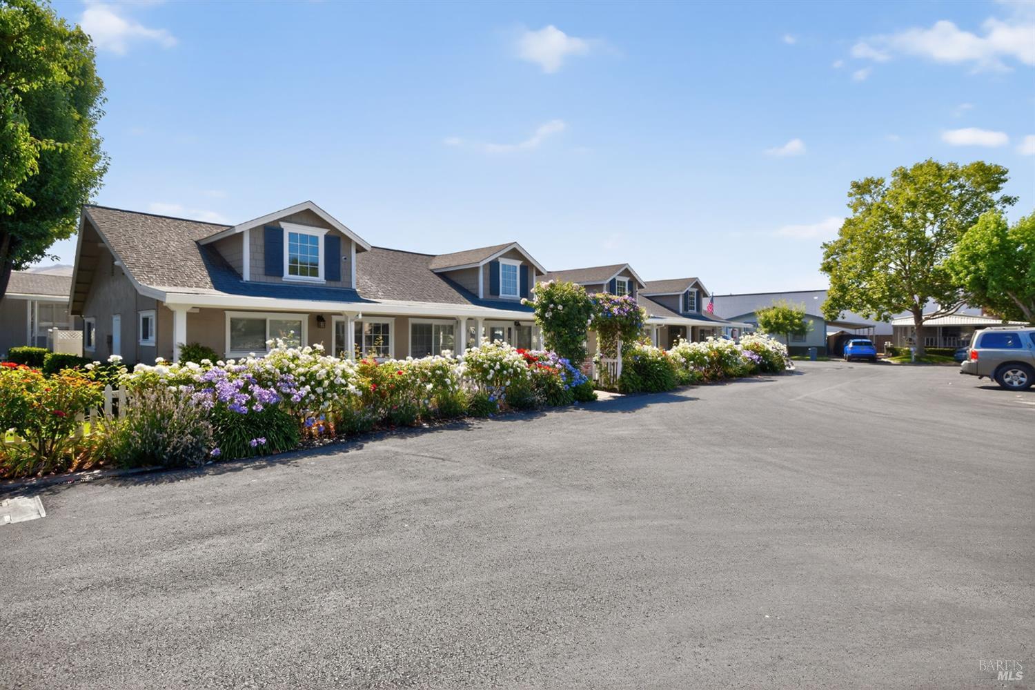 109 Pear Lane, Unit 109 Santa Rosa, CA 95407 - Photo 26 of 27 a front view of a house with a yard and a car park in front of it