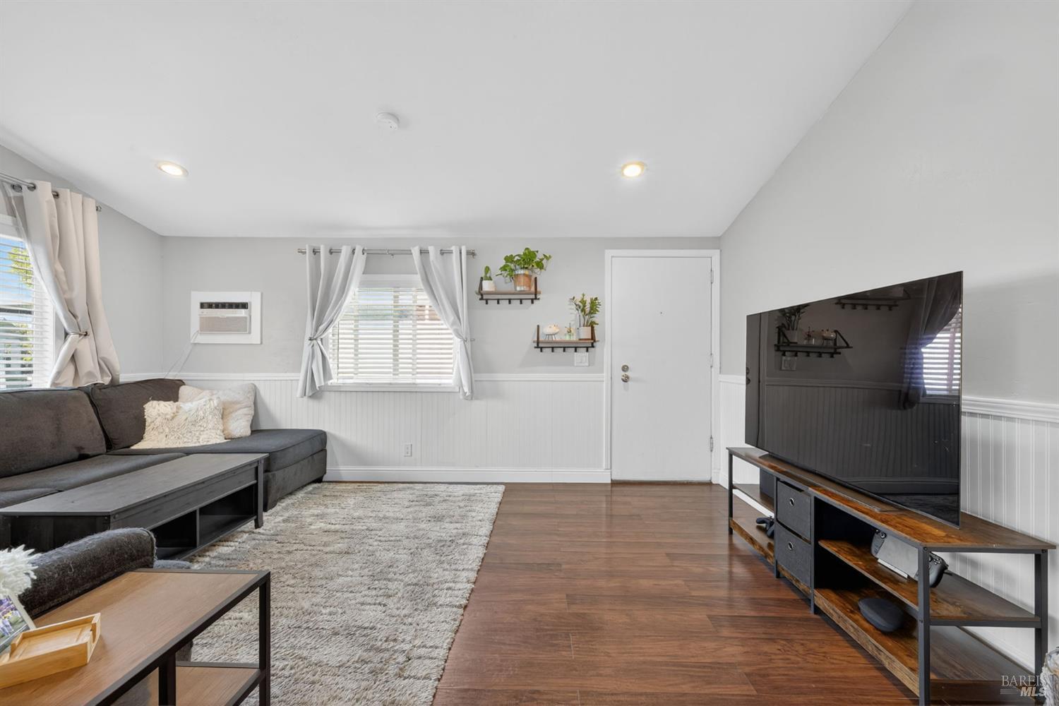 109 Pear Lane, Unit 109 Santa Rosa, CA 95407 - Photo 7 of 27 a living room with furniture and a flat screen tv