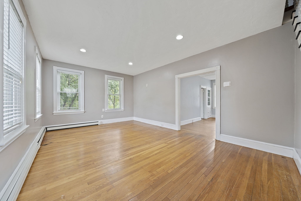 23 Reed Place Whitman, MA 02382 - Photo 15 of 35 a view of an empty room with wooden floor and a window