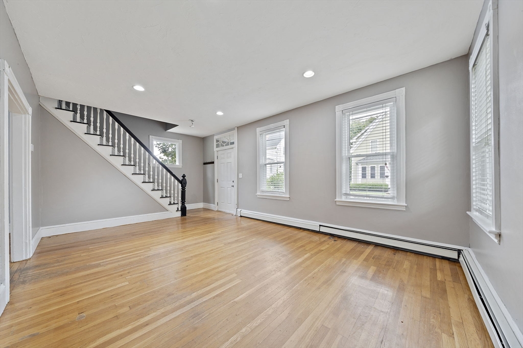 23 Reed Place Whitman, MA 02382 - Photo 17 of 35 a view of an empty room with wooden floor and a window