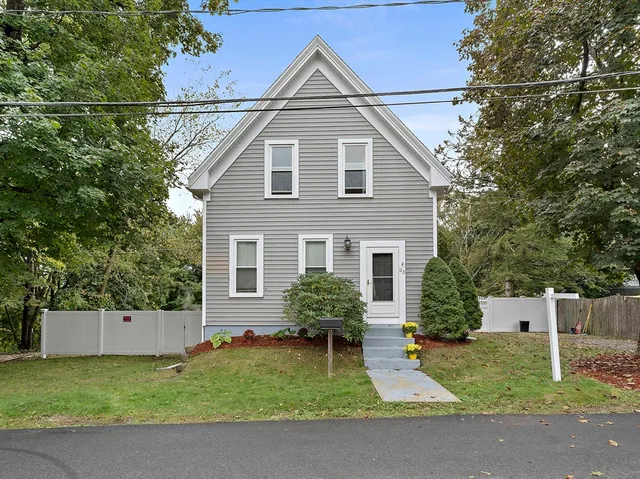 a view of a house with a yard and a fence