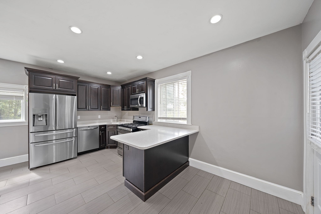 23 Reed Place Whitman, MA 02382 - Photo 6 of 35 a kitchen with a refrigerator and a sink