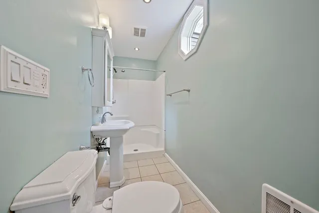 a bathroom with a sink a toilet and mirror