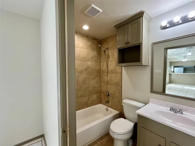 a bathroom with a sink a toilet a mirror and shower