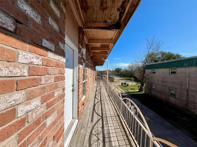 a view of a balcony with wooden floor