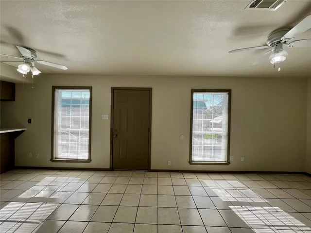 a view of an empty room with windows