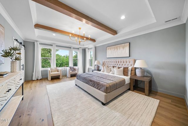 a spacious bedroom with a bed and a large window