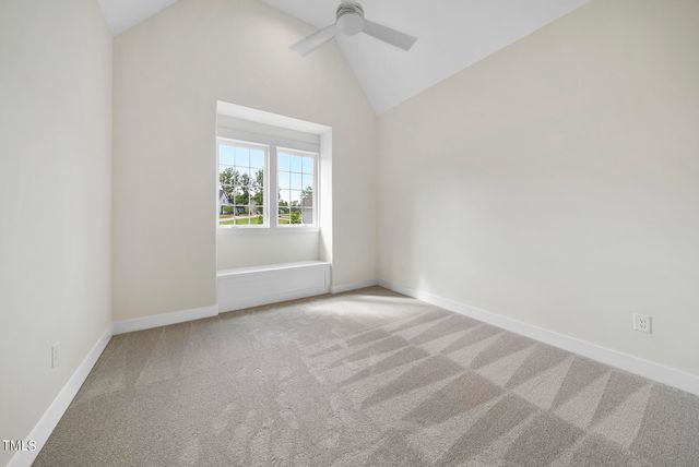 an empty room with windows and a ceiling fan