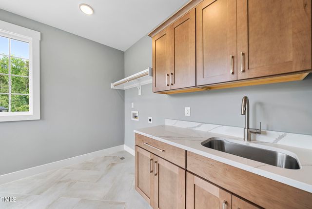 a kitchen with white cabinets and a sink