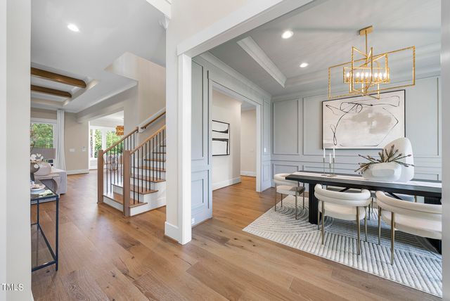 a view of a a dining room with furniture window and wooden floor