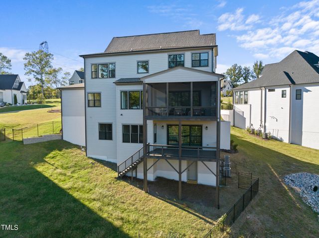 a view of a house with pool and chairs