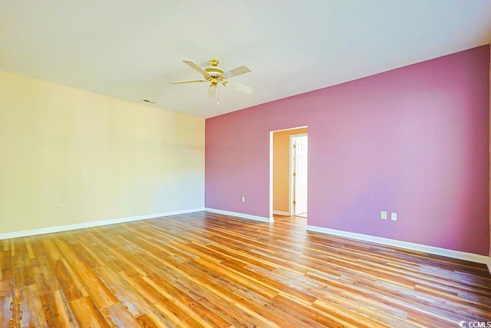 401 Pipers Lane, Unit 401 Myrtle Beach, SC 29575 - Photo 9 of 40 Unfurnished room with light wood-style floors and a ceiling fan
