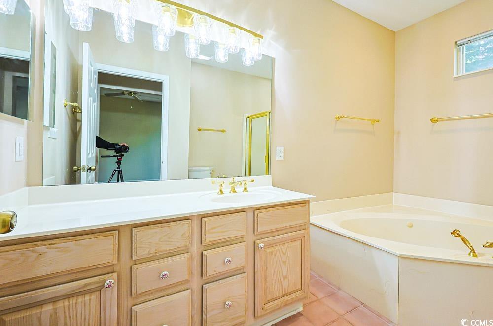 401 Pipers Lane, Unit 401 Myrtle Beach, SC 29575 - Photo 13 of 40 Full bathroom featuring vanity, a bath, and light tile patterned flooring