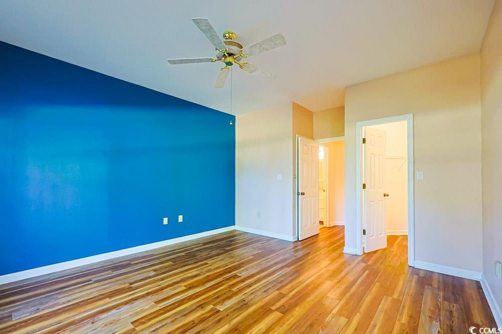 401 Pipers Lane, Unit 401 Myrtle Beach, SC 29575 - Photo 16 of 40 Unfurnished room featuring wood finished floors and a ceiling fan